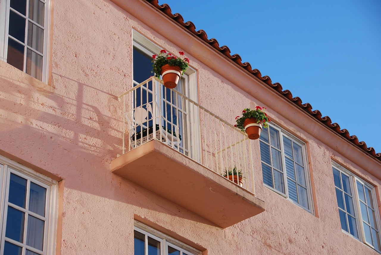 Pressure washing stucco exterior of a CBS home in Cape Coral Florida before repainting
