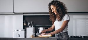 Lady Smiling While Preparing A Meal | Alliance Construction