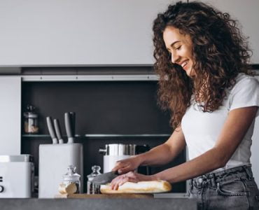 Lady Smiling While Preparing A Meal | Alliance Construction