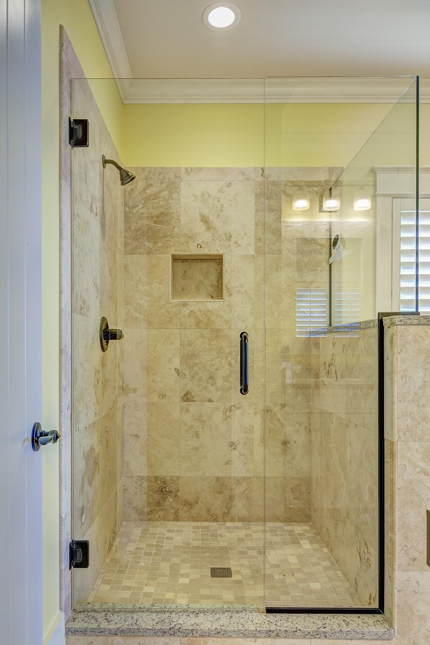 Naples bathroom remodel with large-format porcelain tile and frameless glass shower enclosure
