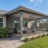 Screened lanai addition on a Cape Coral home with aluminum framing and tropical landscaping