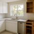 Fort Myers kitchen mid-remodel showing refinished white shaker cabinets next to older cabinets being replaced