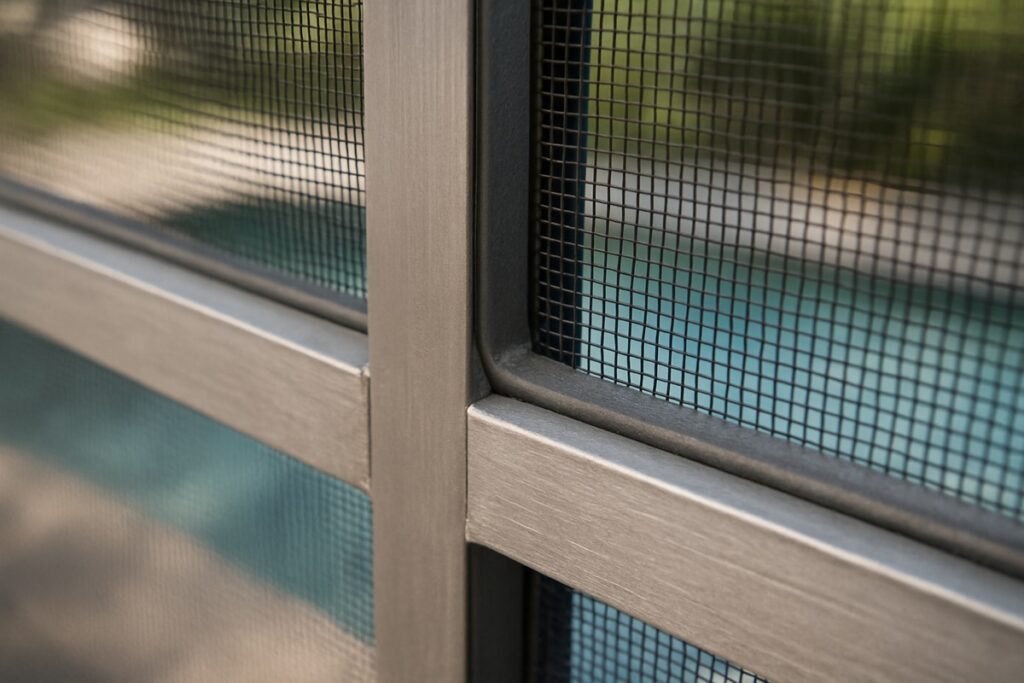Close-up of a screen panel and spline on a pool cage frame