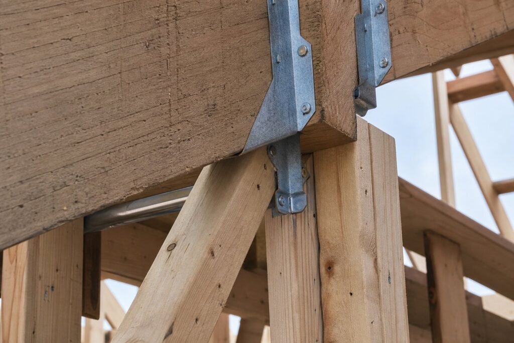 Engineered metal hurricane connectors on second story framing