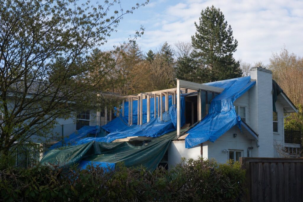 Temporary weather protection over an opened home roof during construction