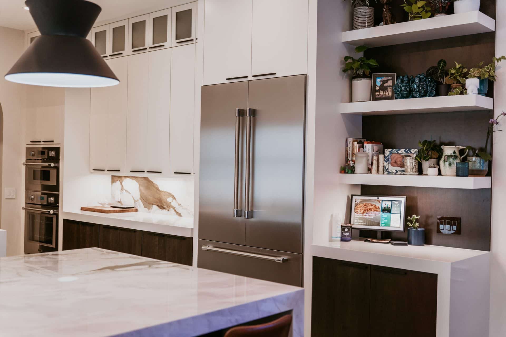 Kitchen remodel detail: integrated refrigerator and custom open shelving