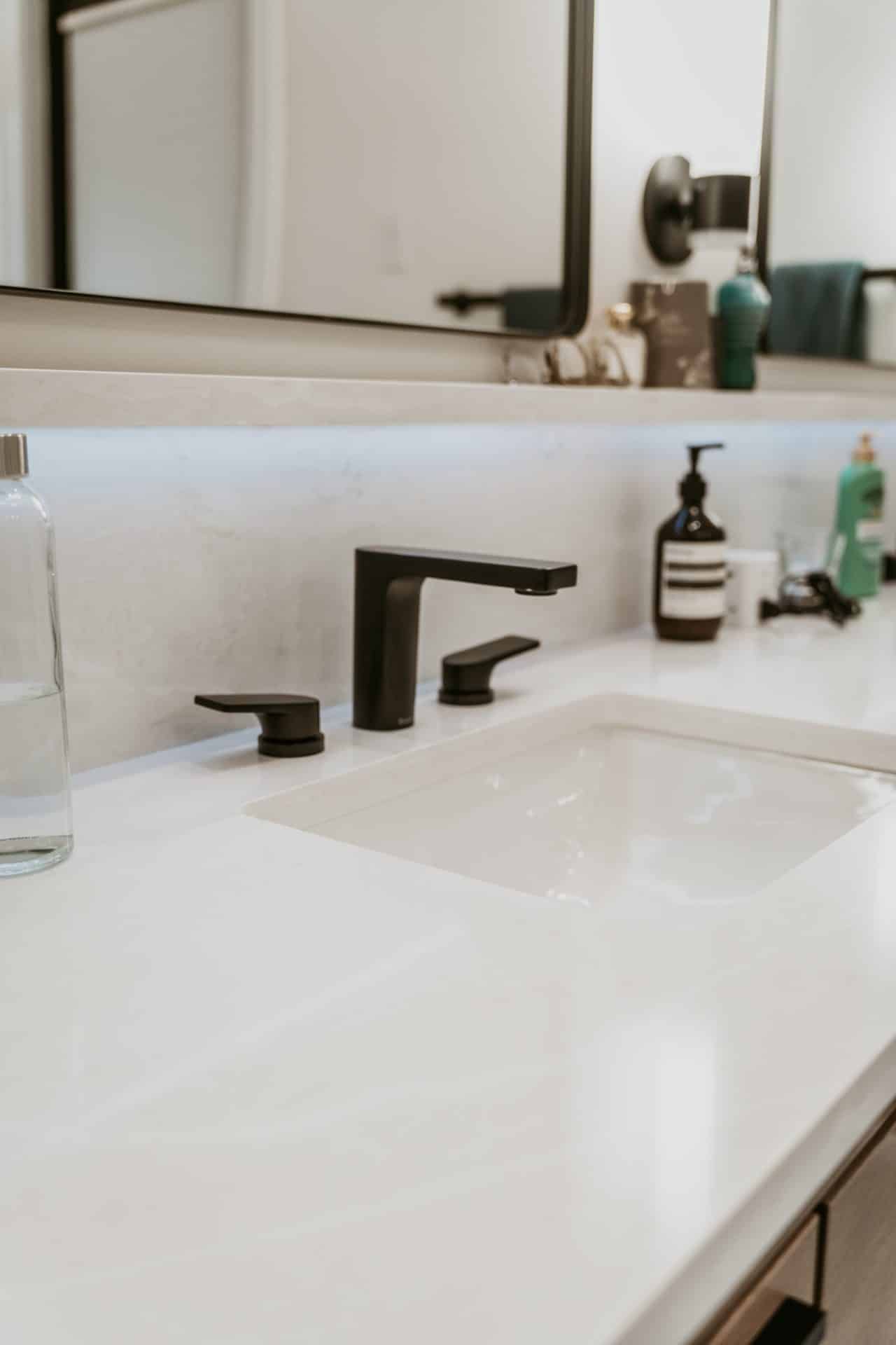 Bathroom vanity detail with matte black fixtures, completed Alliance project