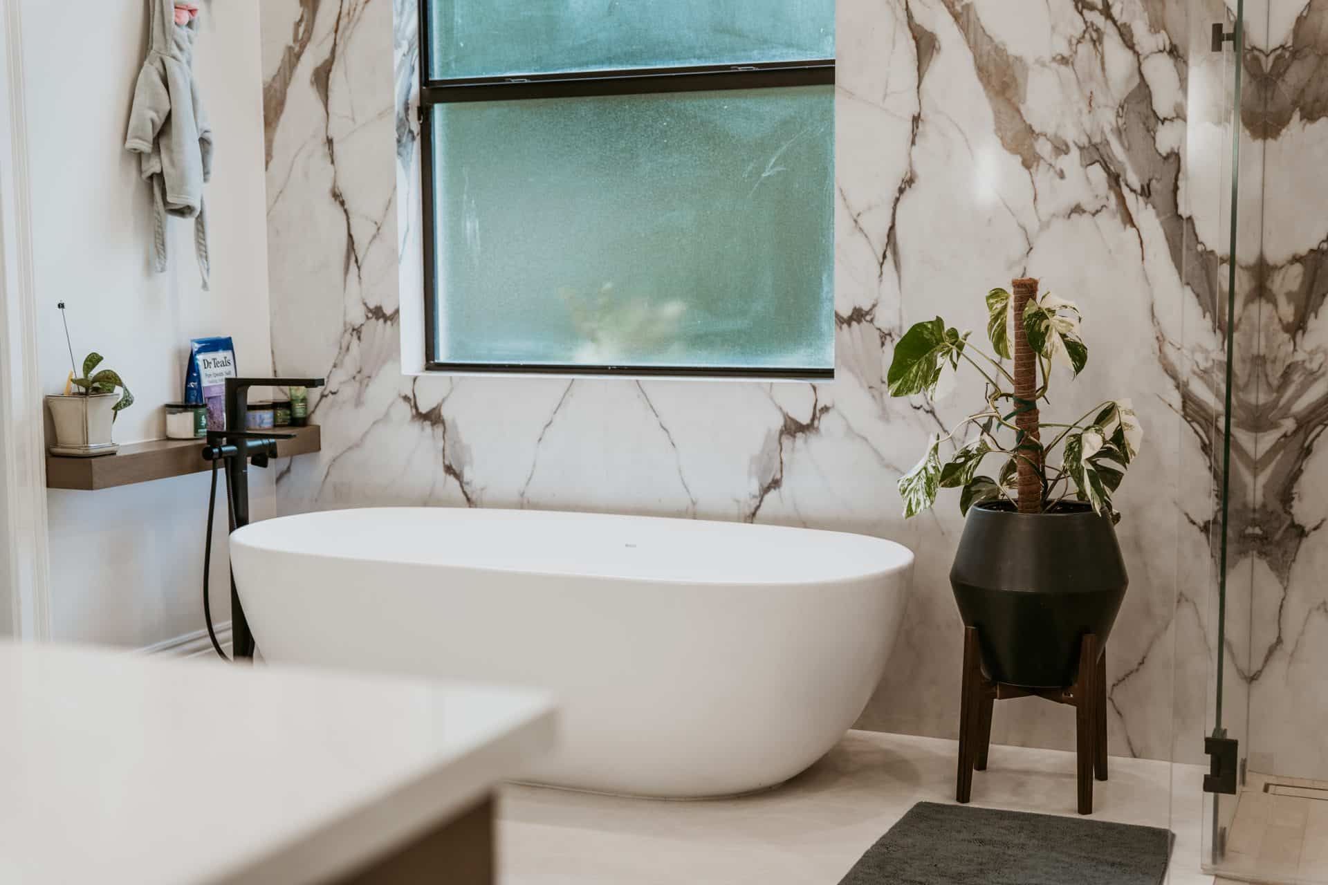Primary bathroom remodel with freestanding tub and marble shower wall, Alliance Construction project