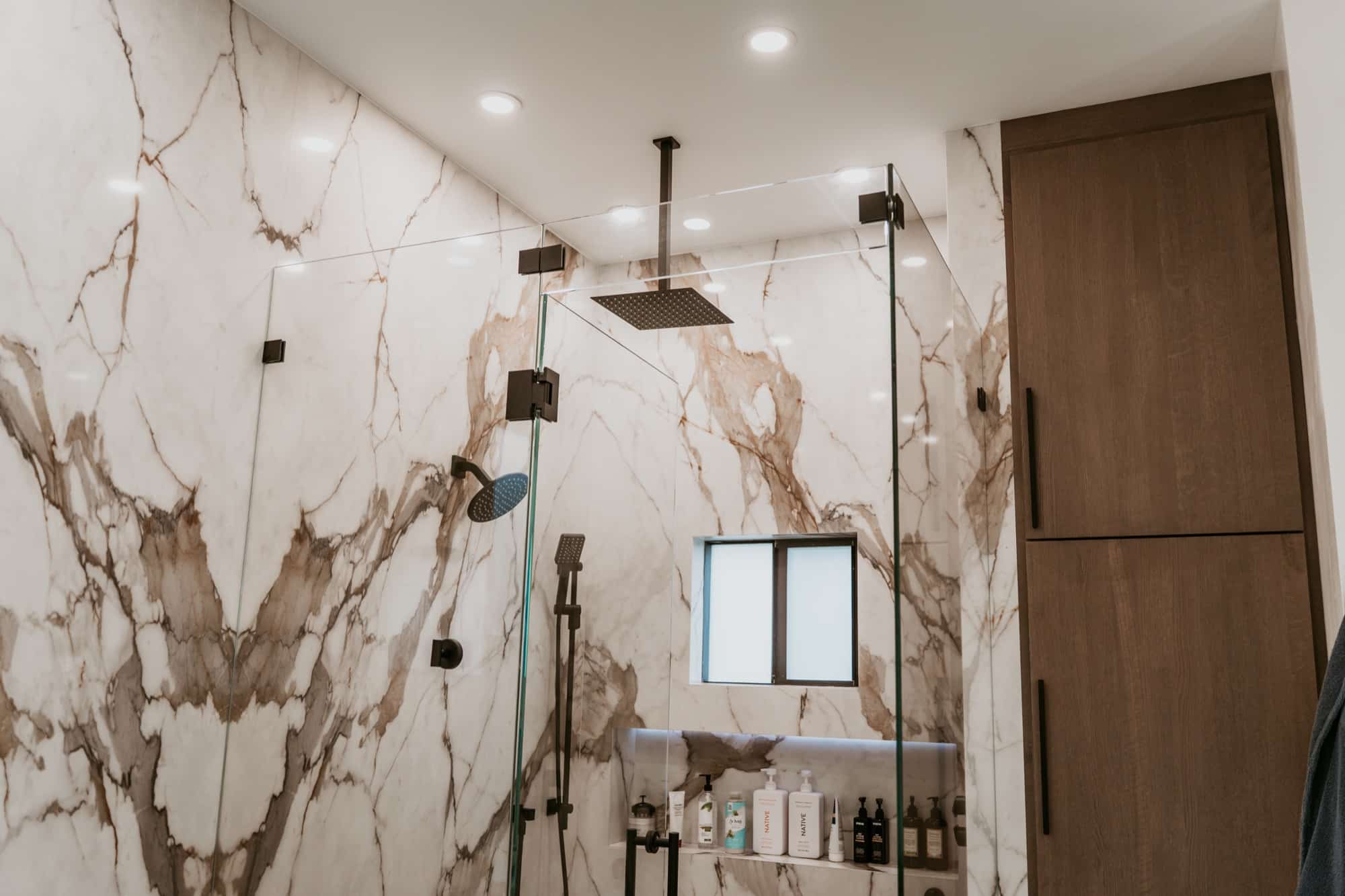 Remodeled primary bathroom with marble shower walls, Alliance Construction project