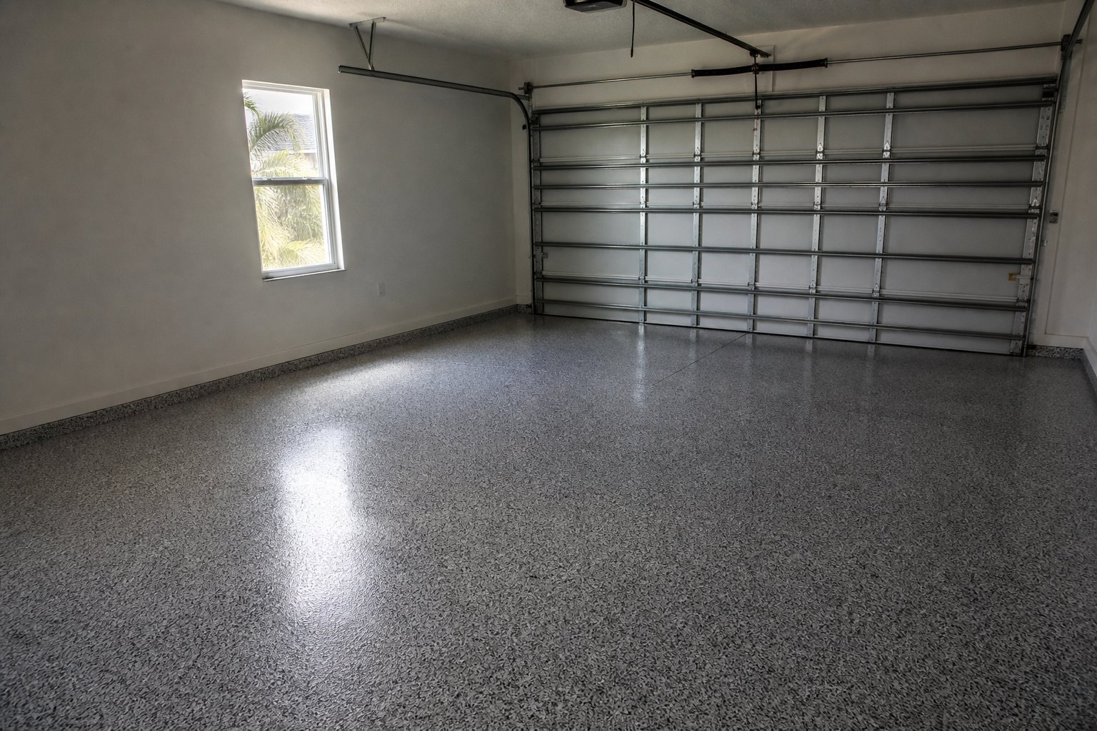 Garage with a finished epoxy flake floor coating in a Cape Coral home
