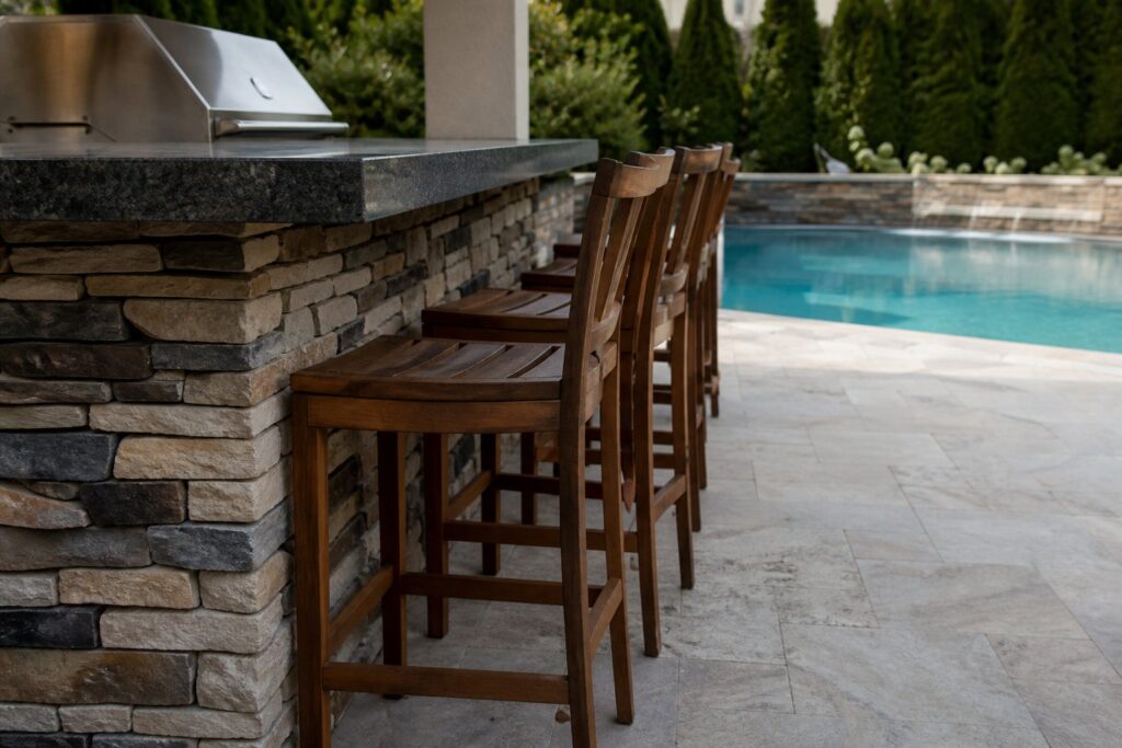 Bar seating at a poolside outdoor kitchen