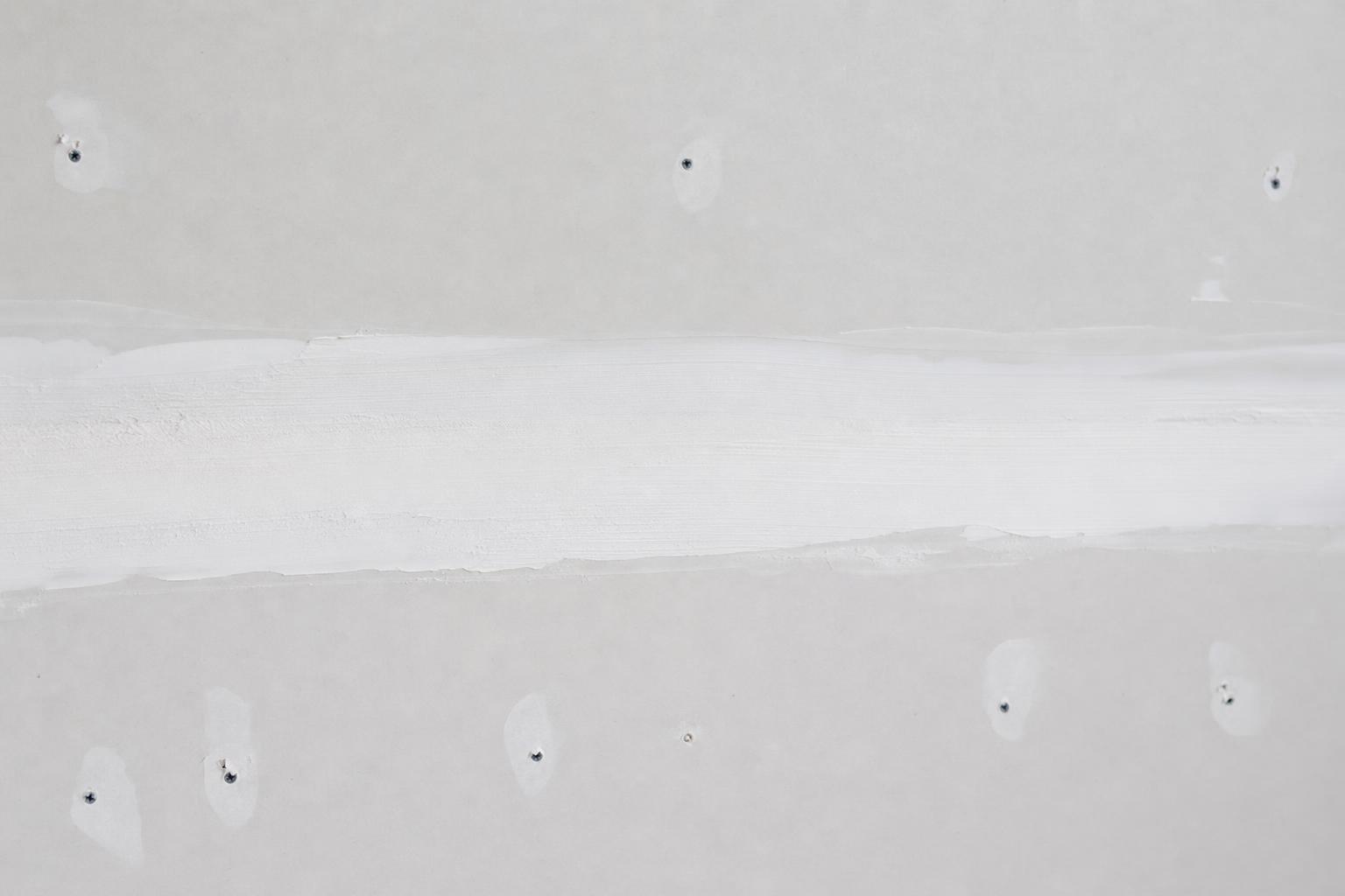 Smooth drywall joints and fastener spots before primer