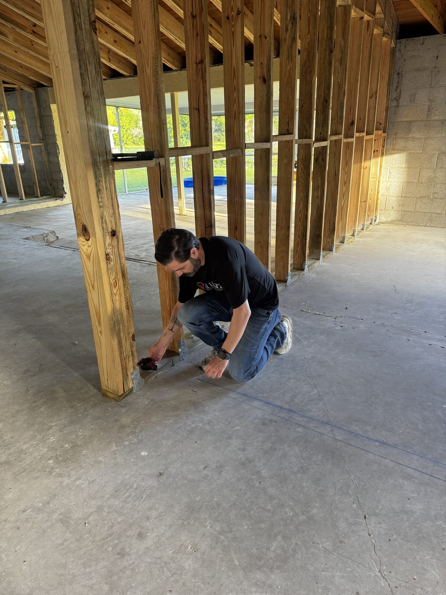 Alliance crew member working on new wall framing inside the home