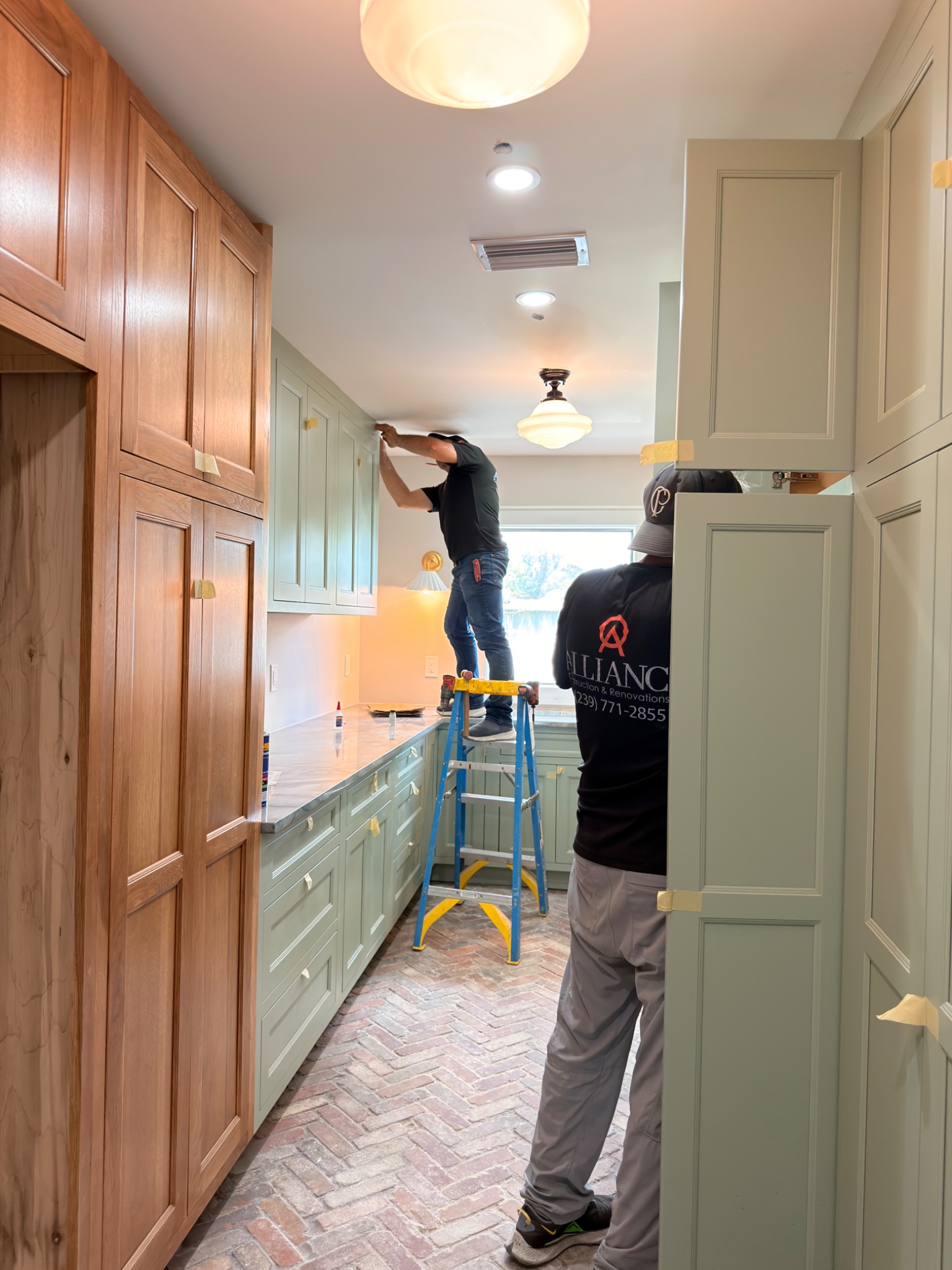 Alliance Construction crew installing custom cabinetry in a Southwest Florida kitchen