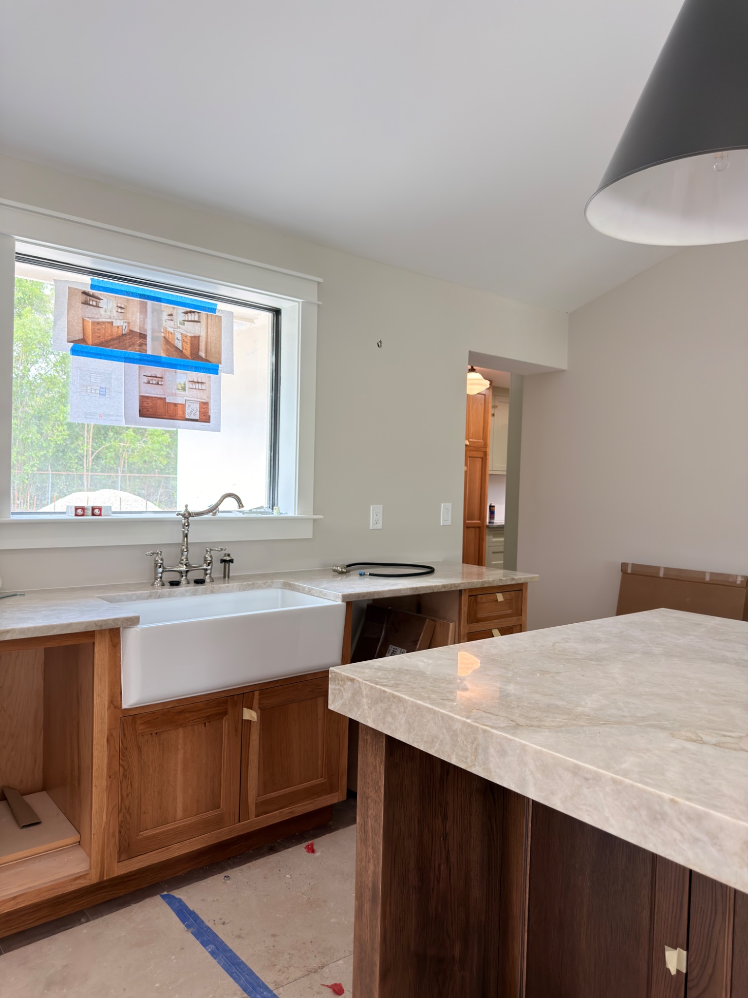 Kitchen remodel in progress with cabinetry, countertops, and island installed
