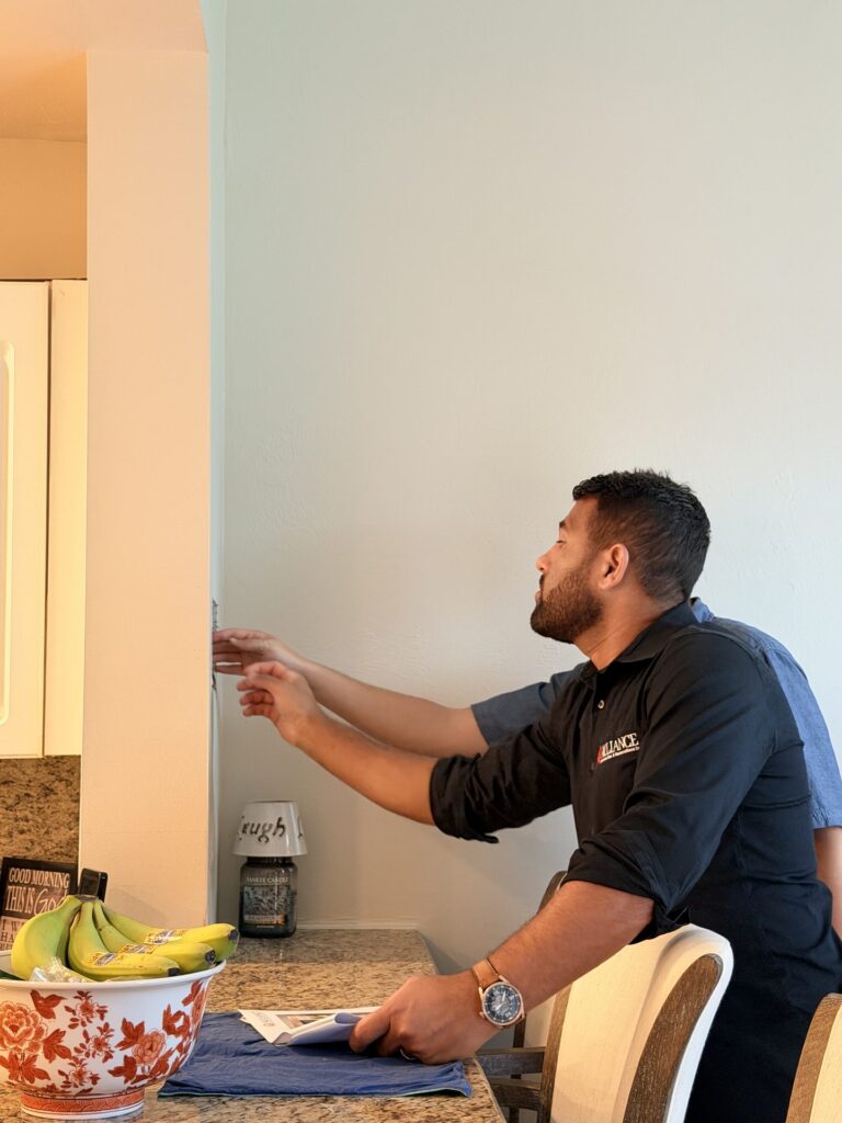 Alliance team measuring the original kitchen in an Eagle Ridge Lakes home in Fort Myers before the remodel