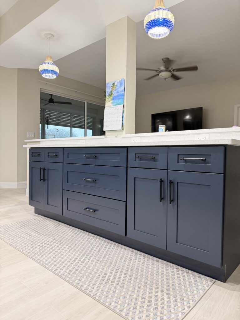Long navy shaker bar with a raised white counter, open to the living room after a half wall was removed